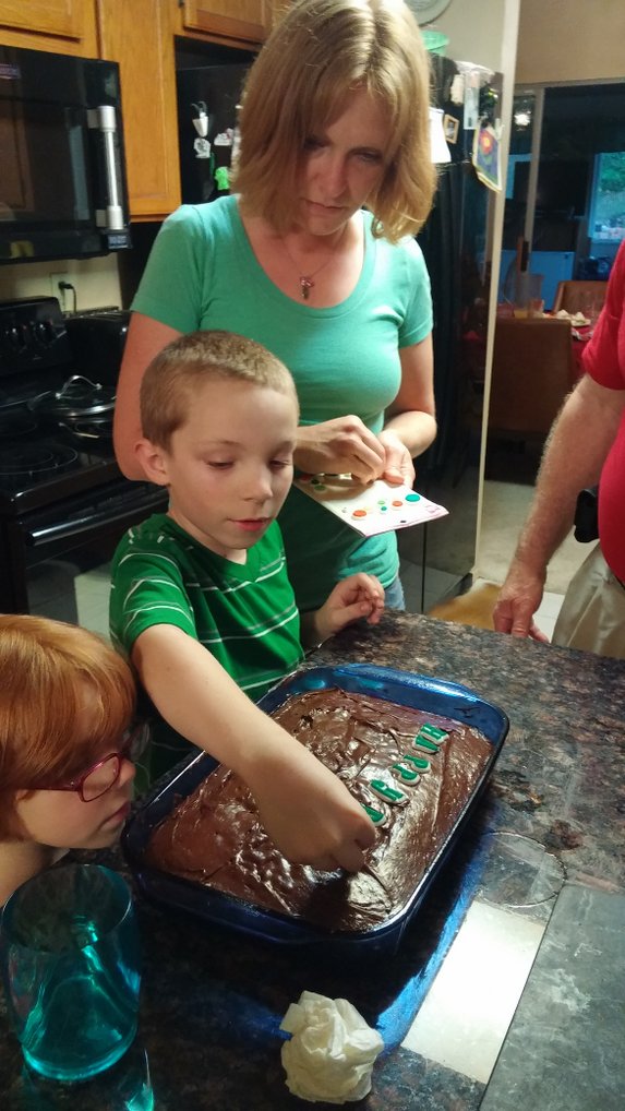 Decorating his own cake