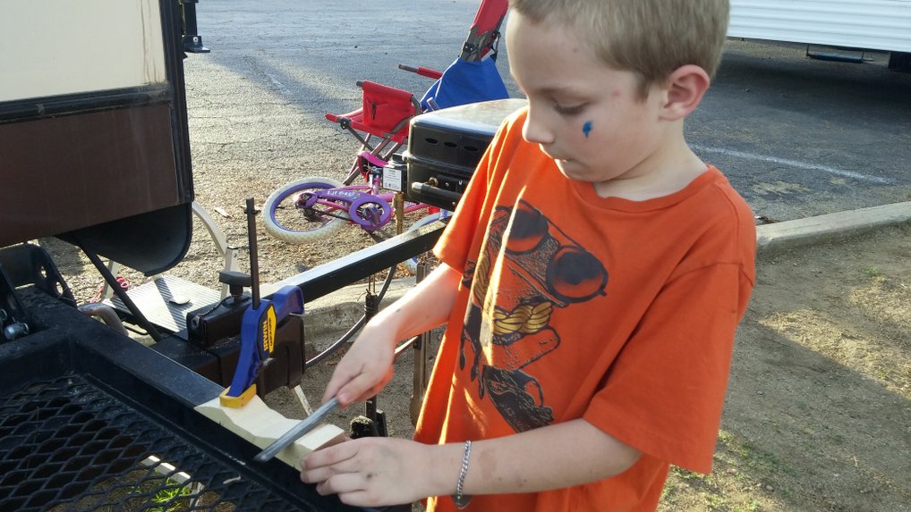 Working on his Pinewood Derby car